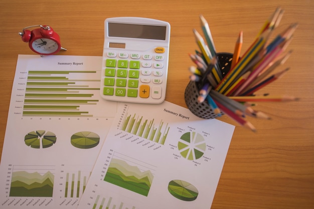 Pile of documents, smartphone and pen. Many graphs and charts. Concept image of data gathering.