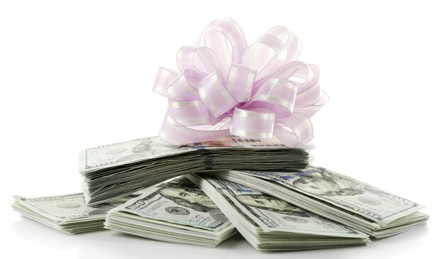 Pile of dollars with bow as gift isolated on white