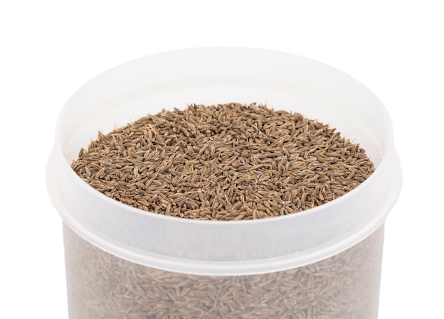 Photo pile of dried cumin seeds on white background