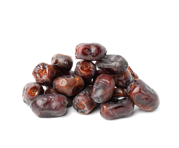 Pile of dried dates on a white background, grade Mazafati, close up