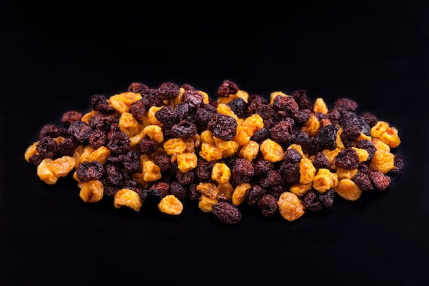 Photo a pile of dried fruits on a black background