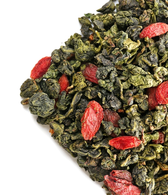 Pile of dry tea with goji berries isolated on white