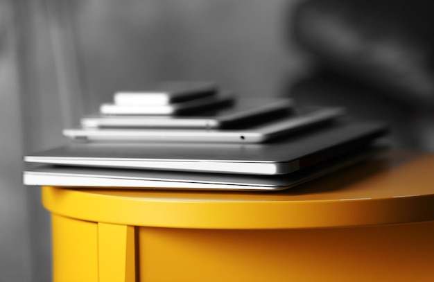 Pile of electronic gadgets on the table Communication and technology concept