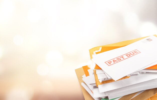 Photo pile of envelopes with overdue utility bills isolated on white