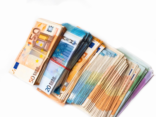 Pile of Euro banknotes on a white paper selective focus