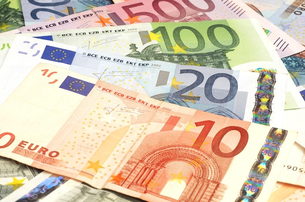 A pile of euro banknotes with the number 10 on them.