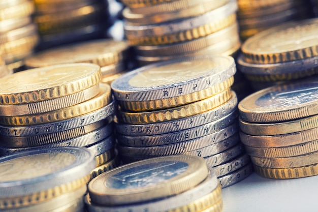 Pile of euro coins stacked in towers - macro shot.