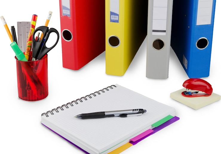 Photo pile of files in folders and notebook on white table