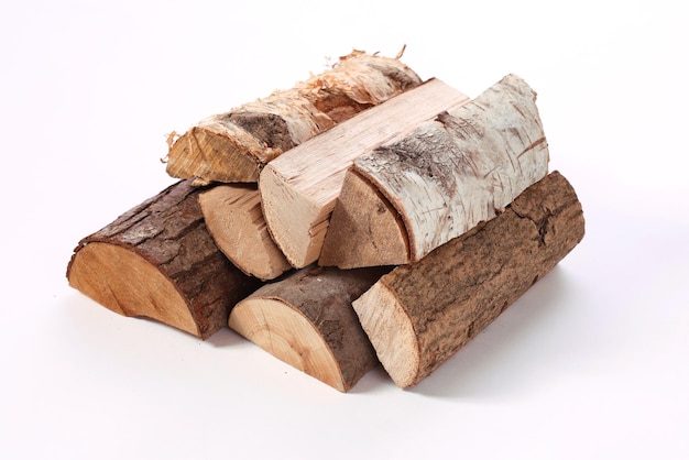 Pile of firewood of different types in white studio