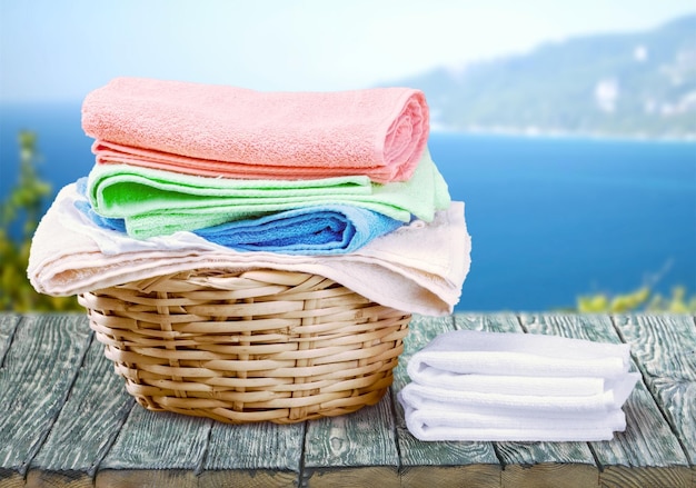 Pile of fluffy towels  and wicker basket