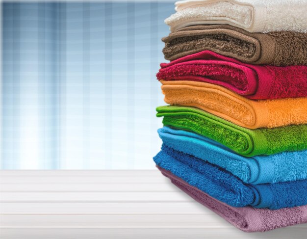 Pile of fluffy towels on wooden table