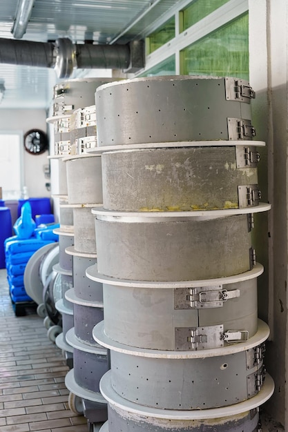 Pile of forms for Gruyere de Comte Cheese at the dairy at Franche Comte, Burgundy, of France. As a part of the process of production