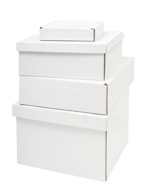 Pile of four blank white cardboard boxes of different sizes isolated on white background