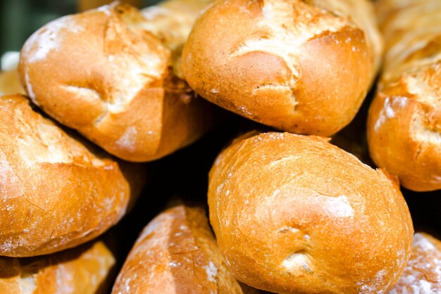 Pile of French bread on shelf in bakery