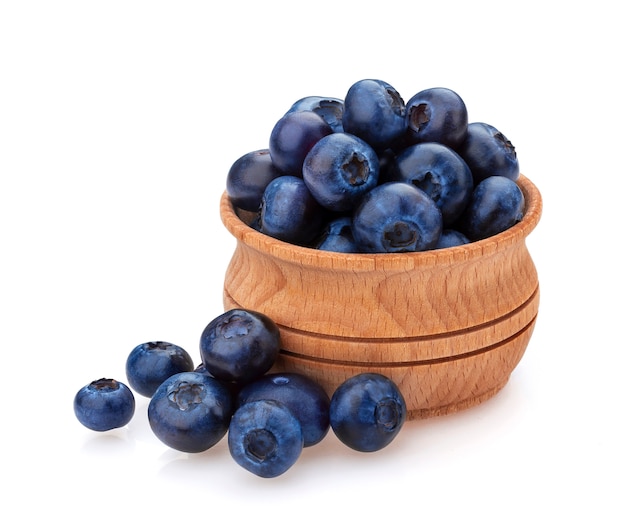  A pile of fresh blueberries in a wooden bowl
