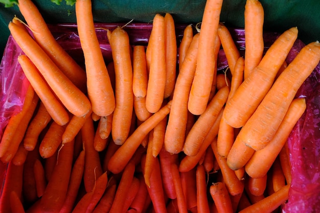 pile of fresh carrots on traditional market shelf. Daucus carota.