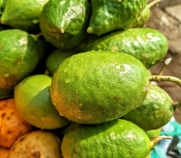 A pile of fresh green lemon fruit