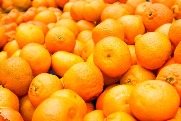 Pile of fresh oranges at market