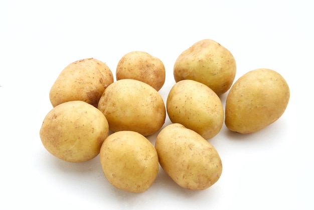 A pile of fresh organic baby potatoes on white background Close up Selected focus