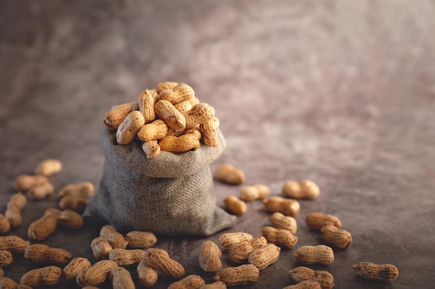 Pile of fresh organic Peanuts in jute bag