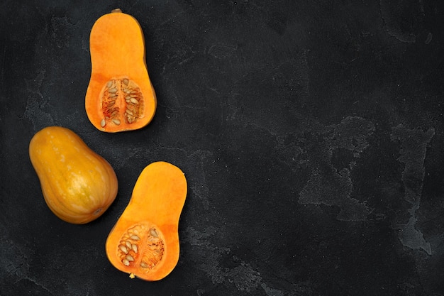 Pile of fresh pumpkins on dark background