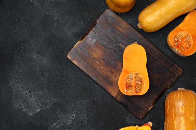 Pile of fresh pumpkins on dark table top view