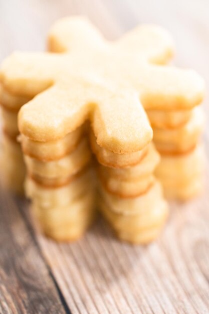 Pile of freshly baked sugar cookies in snowflake shape