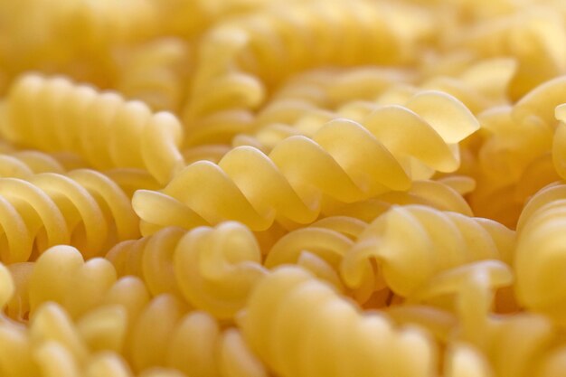 A pile of fusilli pasta texture background