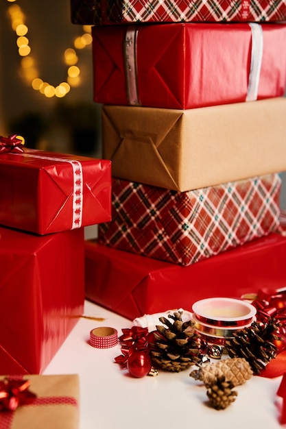 Photo pile of gift boxes wrapping in craft paper on table, presents for winter holidays