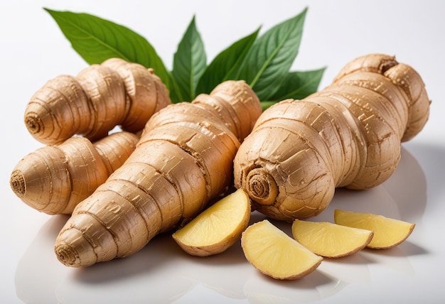 a pile of ginger with a green leaf next to it