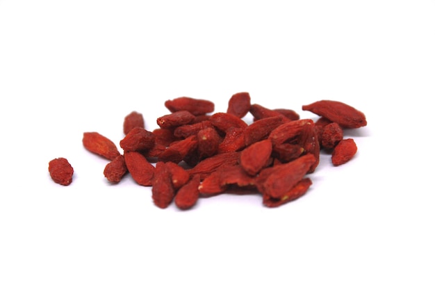 A pile of goji berries on a white background