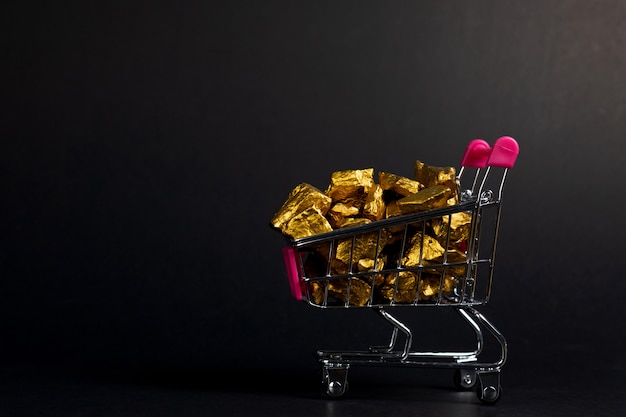 A pile of gold nuggets in shopping cart trolley