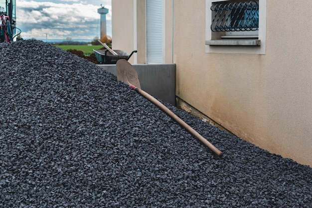 Pile of gravels in front of a house for exterior landscaping work paths and parkings