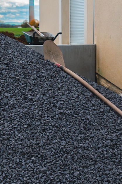 Pile of gravels in front of a house for exterior landscaping work paths and parkings