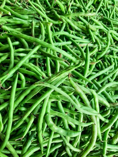 A pile of green beans is shown with the word green on it.