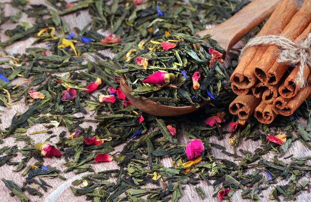 a pile of green and pink flowers with a wooden spoon.