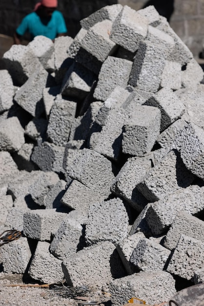 A pile of grey cinder blocks with the word concrete on it.