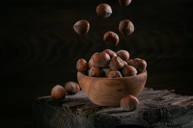 Pile of hazelnuts filbert in a wooden bowl 