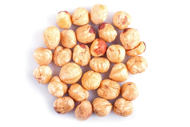 Pile of hazelnuts isolated on white background