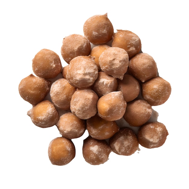 A pile of hazelnuts on a white background