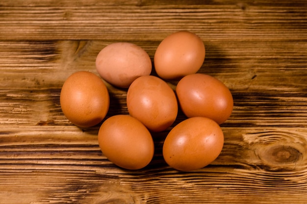 Pile of the hen eggs on wooden table