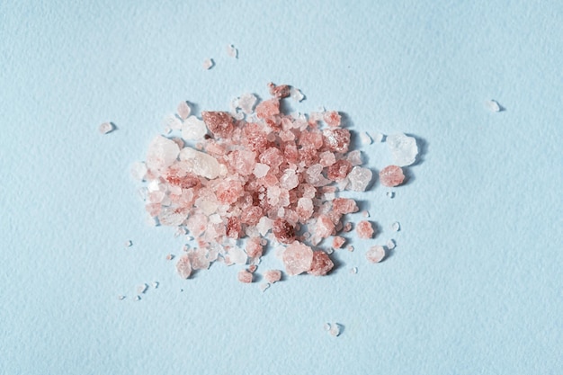 Pile of Himalayan pink salt on blue close up