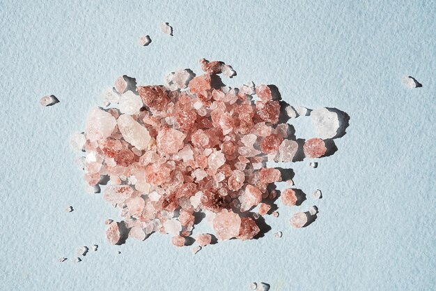 Pile of Himalayan pink salt on blue close up