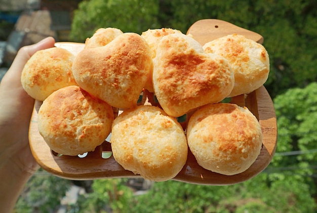Pile of Homemade Pao de Queijo or Brazilian Cheese Breads with Pair of the Heart Shaped on Top