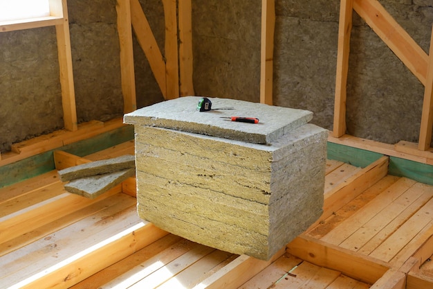 Pile of insulation material for work of warming walls of house under construction