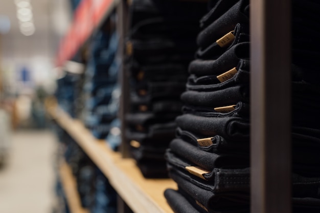 Pile of jeans on a shop window in the store.