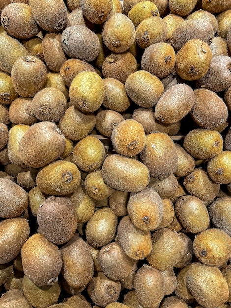 a pile of kiwi fruit in a market