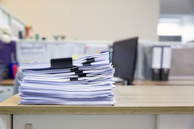 Photo pile of a lot papers documents on desk office stack up.