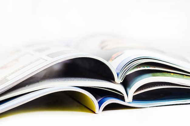 a pile of magazines close up on white background