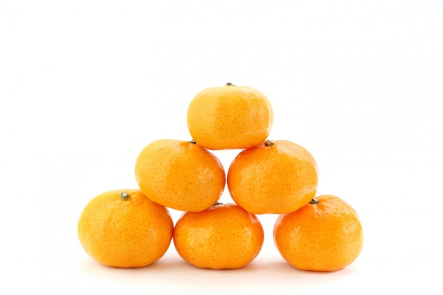 Pile of many orange fruits on white background